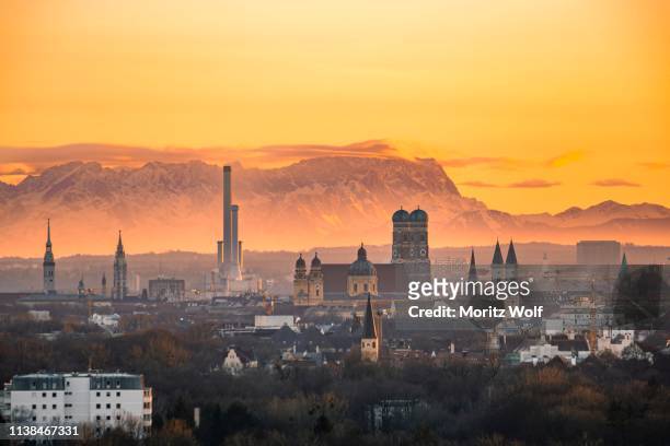 view over munich with church of our lady, theatine church, ludwigskirche, behind zugspitze at sunset, munich, bavaria, germany - munich cityscape stock pictures, royalty-free photos & images
