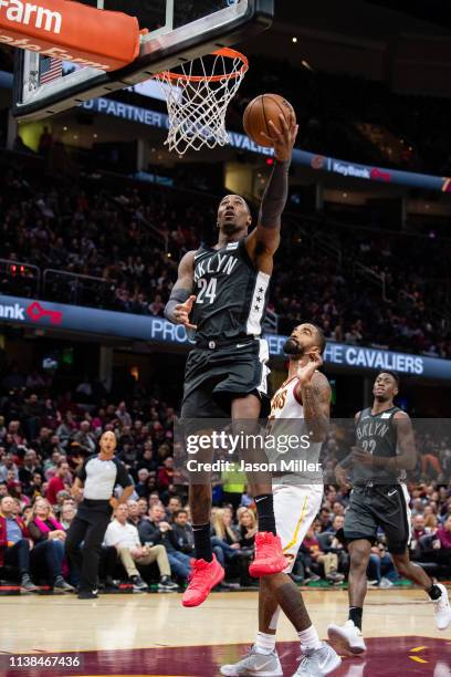 Rondae Hollis-Jefferson of the Brooklyn Nets shoots over JR Smith of the Cleveland Cavaliers during the second half at Quicken Loans Arena on October...