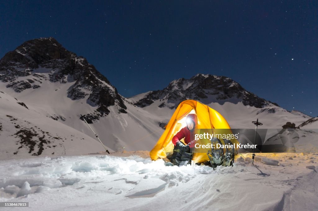 Snowshoe hikers in an illuminated tent in the snow on the Maedelejoch, night shot, near Kemptner Huette, Allgaeu Alps, Tyrol, Austria