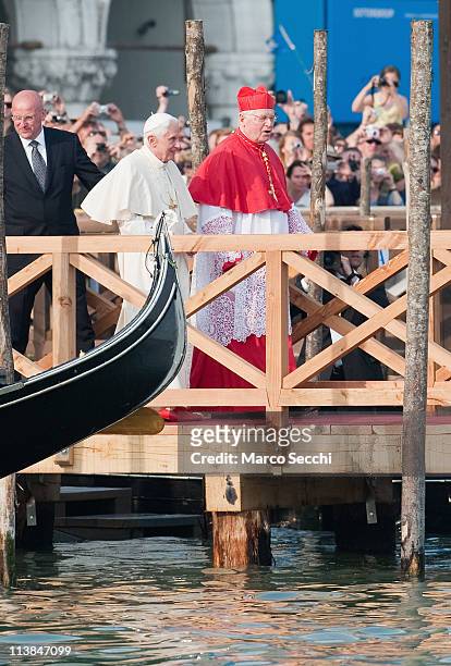 Pope Benedict XVI walks on a pontoon in St. Mark's Square accompanied by Angelo Scola Patriarch of Venice to board a Gondola on May 8, 2011 in...