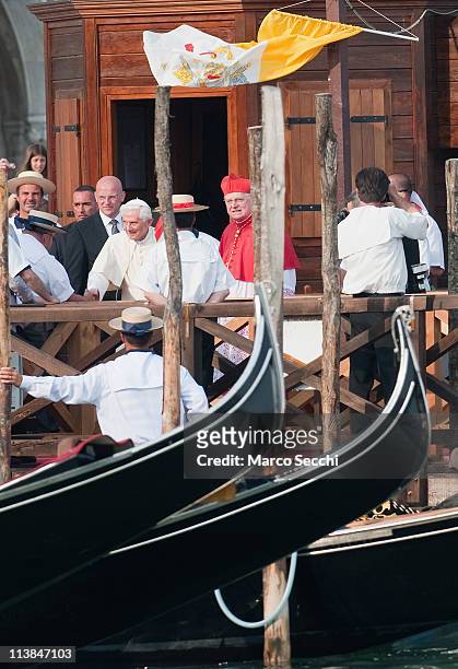 Pope Benedict XVI walks on a pontoon in St. Mark's Square accompanied by Angelo Scola Patriarch of Venice to board a Gondola on May 8, 2011 in...