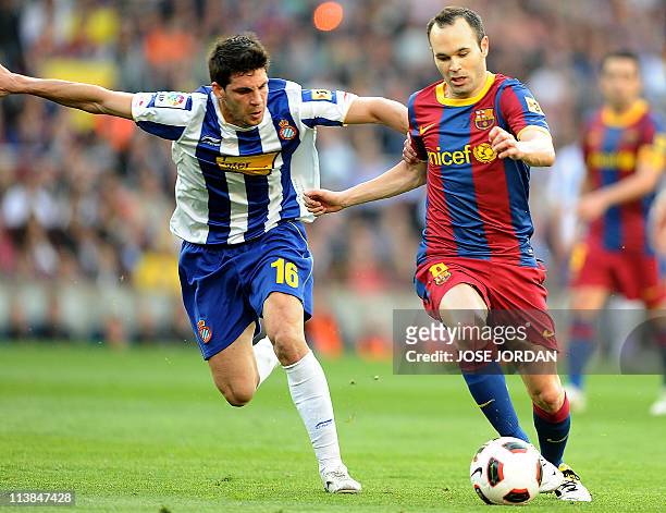 Espanyol's midfielder Javi Lopez vies for the ball with Barcelona's midfielder Andres Iniesta during the Spanish league football match between...