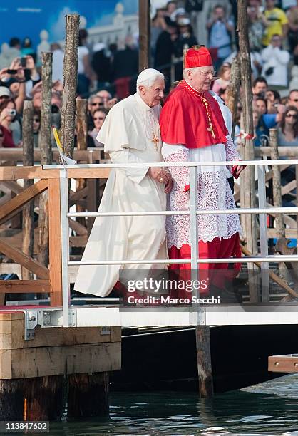 Pope Benedict XVI walks on a pontoon in St. Mark's basin accompanied by Angelo Scola Patriarch of Venice to board a Gondola on May 8, 2011 in Venice,...