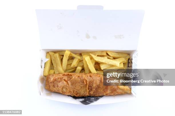 a portion of cod and chips sit in a cardboard box - fish and chips stock pictures, royalty-free photos & images