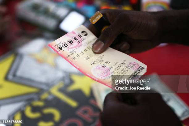 George Hollins buys a Powerball ticket at the Shell Gateway store on March 26, 2019 in Boynton Beach, Florida. Wednesday's Powerball drawing will be...
