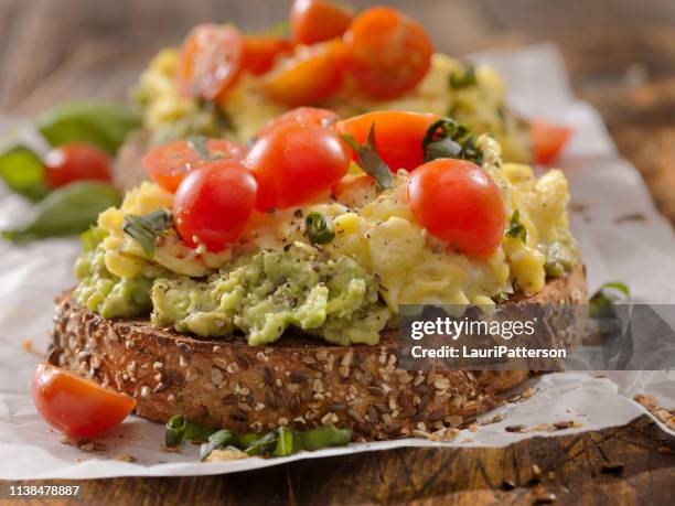 creamy avocado sandwich with scrambled eggs and tomatoes - avocado toast stock pictures, royalty-free photos & images