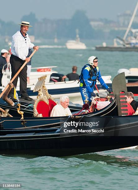 Pope Benedict XVI sits aboard the Dogaressa gondola escorted by several gondolas and a police officer on a jet ski across St Mark's basin on May 8,...