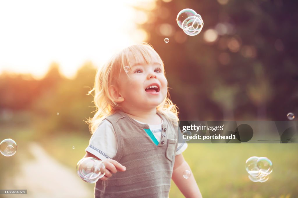 Little child and soap bubbles