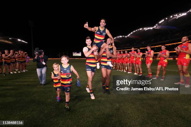 Eddie Betts of the Crows is chaired of by team mates Bryce Gibbs and Cameron Ellis-Yolmen after his 300th game during the 2019 AFL round 05 match...