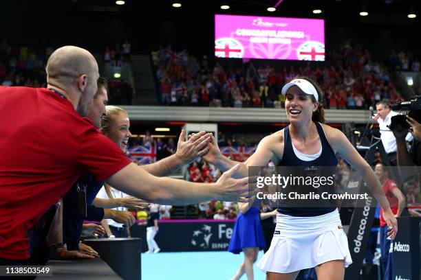 Johanna Konta of Great Britain celebrates with team mates and staff after winning her second singles match against Kazakhstan's Yulia Putintseva...