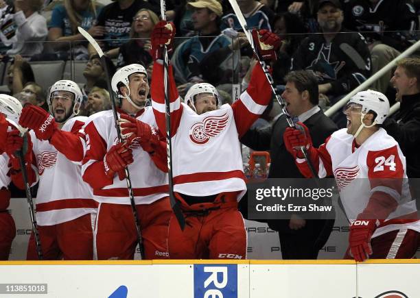 Drew Miller , Jonathan Ericsson, Niklas Kronwall and Ruslan Salei of the Detroit Red Wings celebrate on the bench after Tomas Holmstrom of the...