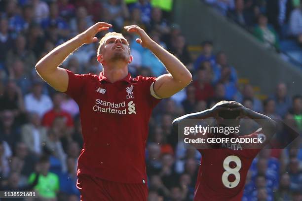 Liverpool's English midfielder Jordan Henderson reacts after missing a chance during the English Premier League football match between between...