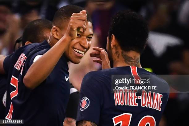 Paris Saint-Germain's French forward Kylian Mbappe celebrates with Paris Saint-Germain's Brazilian forward Neymar after scoring his team's third goal...