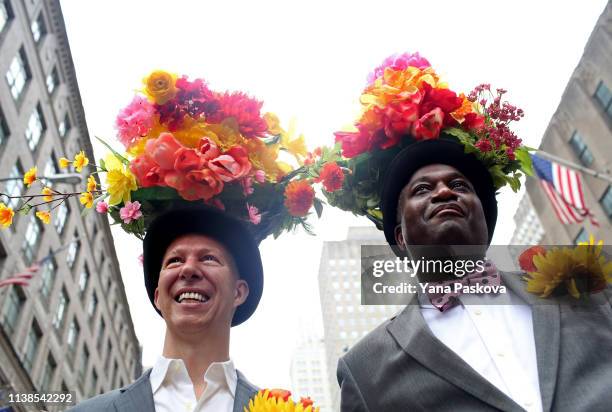 Tom Nickel and Dwayne Skeete wear flower hats in Midtown East for the annual Easter Parade on April 21, 2019 in New York City. Each year New Yorkers...