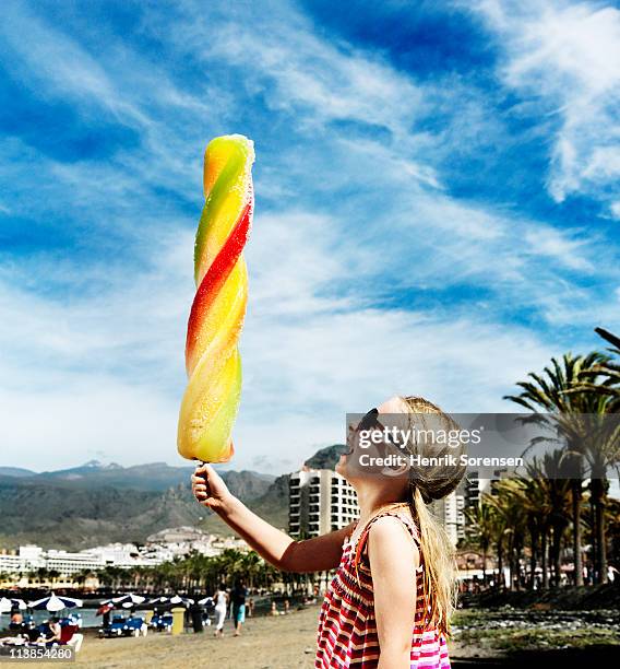 holiday girl with oversized ice-cream in hand - man made object stock pictures, royalty-free photos & images