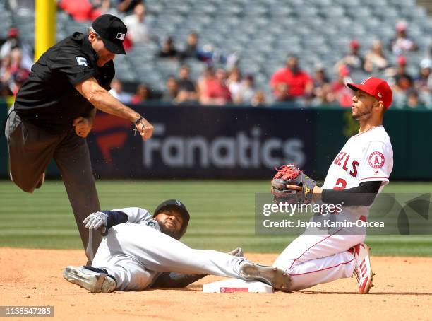 Umpire Angel Hernandez calls out Domingo Santana of the Seattle Mariners on a throw to Andrelton Simmons of the Los Angeles Angels of Anaheim from...