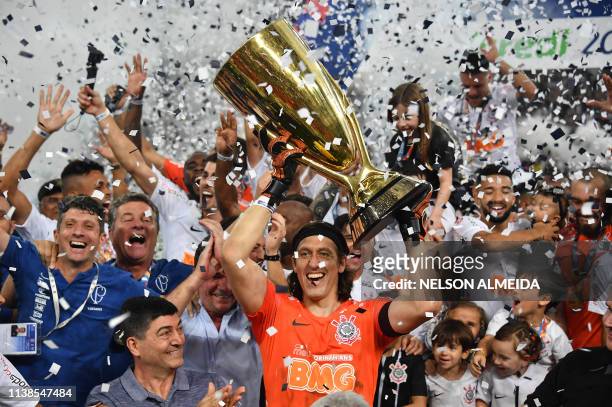 Corinthians captain, goalkeeper Cassio , holds up the cup after the Paulista championship final football match against Sao Paulo at the Arena...