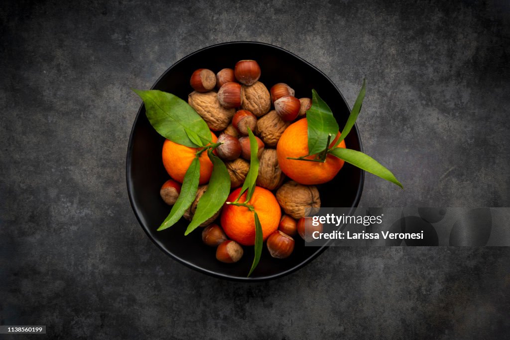 Bowl of clementines, walnuts and hazelnut