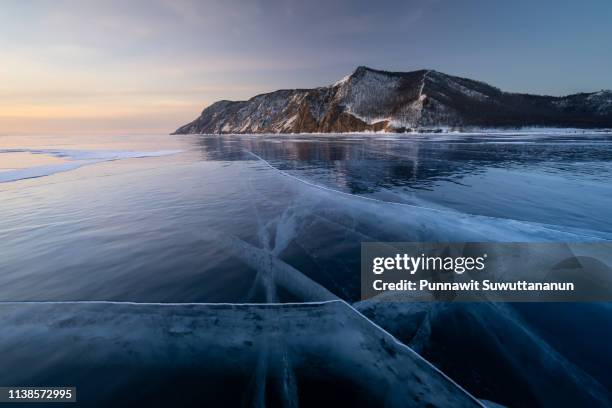 uzury bay at baikal lake iin winter season in a morning sunrise, siberia, russia - frozen water stock-fotos und bilder