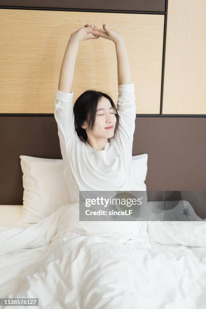 young asian woman, resting in bed - korea apartment woman stock pictures, royalty-free photos & images