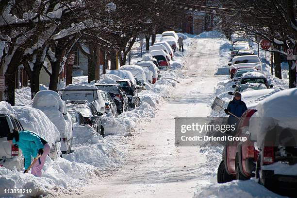 shoveling out in a suburban neighborhood. - snowdrift stock pictures, royalty-free photos & images