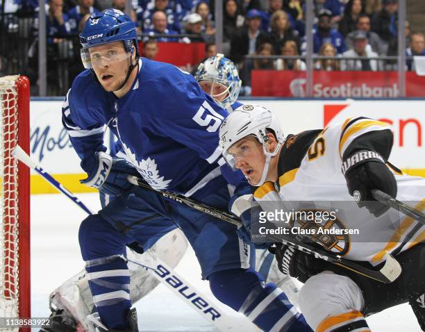 Jake Gardiner of the Toronto Maple Leafs ties up Noel Acciari of the Boston Bruins in Game Six of the Eastern Conference First Round during the 2019...