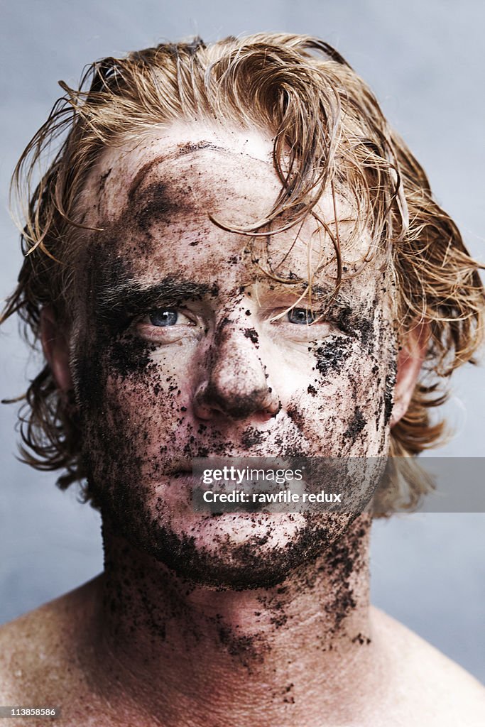 Redhead with mud on his face