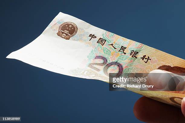 man holding chinese twenty yuan note - 20 yuan note stock pictures, royalty-free photos & images