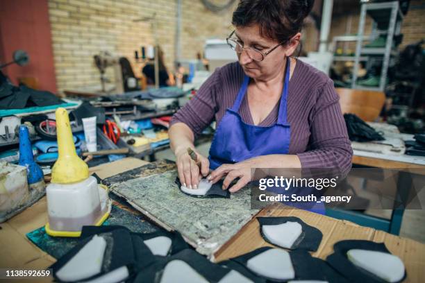 mature woman working in shoe factory - insoles stock pictures, royalty-free photos & images