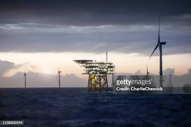 offshore platform - substation and wind farm in sunset - wind stock pictures, royalty-free photos & images
