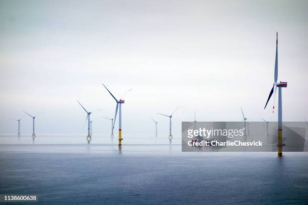 big offshore wind-farm with transfer vessel - a boat on the ocean stock pictures, royalty-free photos & images