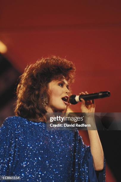 Marie Osmond, U.S. Country music singer, singing into a microphone during a live concert performance at the International Festival of Country Music,...