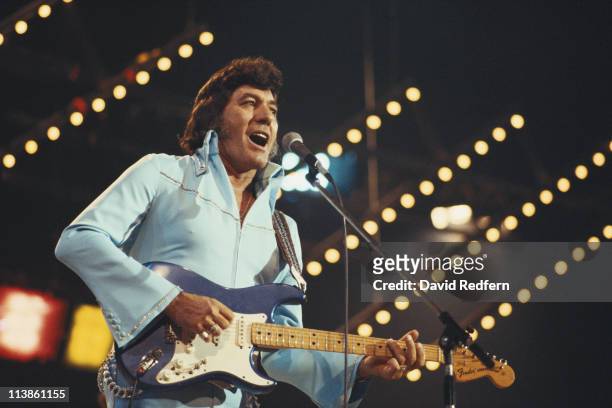 Carl Perkins , U.S. Rock and roll singer-songwriter and guitarist, playing the guitar during a live concert performance at the International Festival...