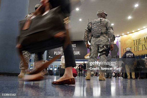 Members of the United States Army stand guard as Transportation Secretary Ray LaHood speaks to the media regarding national high-speed rail service...