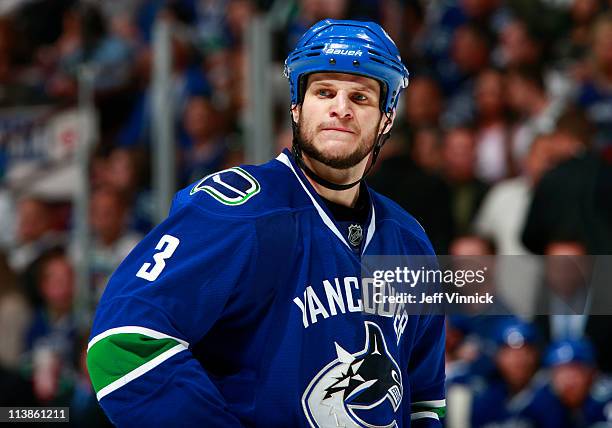 Kevin Bieksa of the Vancouver Canucks looks on from the bench in Game Five of the Western Conference Semifinal against the Nashville Predators in the...