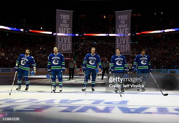 Chris Higgins, Christian Ehrhoff, Alexander Edler, Mason Raymond and Ryan Kesler of the Vancouver Canucks listen to the national anthems in Game Five...