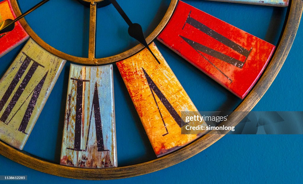 Close-up of clock on blue wall