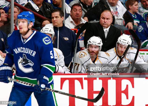 Christian Ehrhoff of the Vancouver Canucks skates by the Nashville Predators bench in Game Five of the Western Conference Semifinal during the 2011...