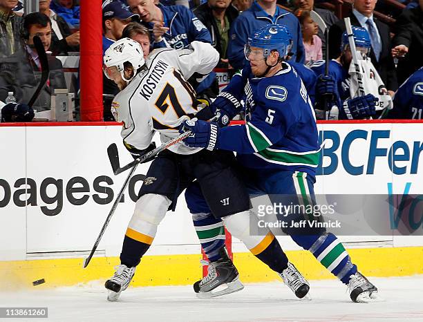 Christian Ehrhoff of the Vancouver Canucks checks Sergei Kostitsyn of the Nashville Predators in Game Five of the Western Conference Semifinal during...
