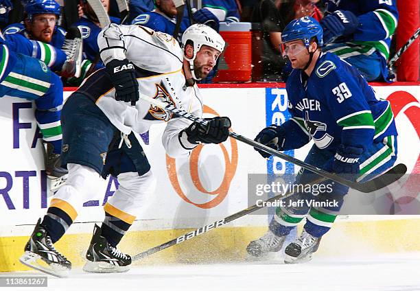 Cody Hodgson of the Vancouver Canucks looks on as David Legwand of the Nashville Predators passes the puck up ice in Game Five of the Western...