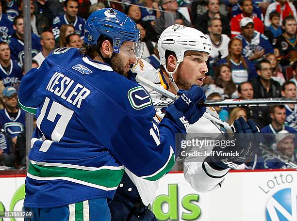 Ryan Kesler of the Vancouver Canucks checks Shane O'Brien of the Nashville Predators in Game Five of the Western Conference Semifinal during the 2011...