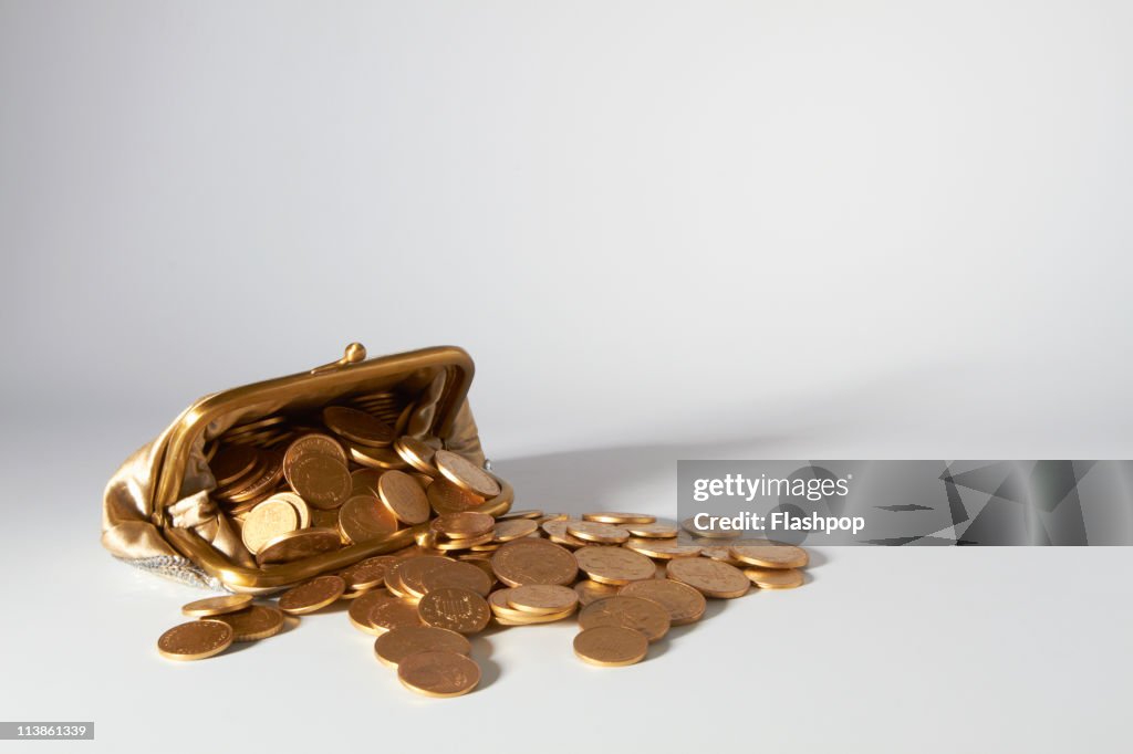 Purse overflowing with coins