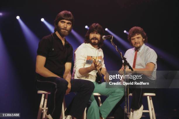Alabama , U.S. Country music band, pose sitting on stools, circa 1980..