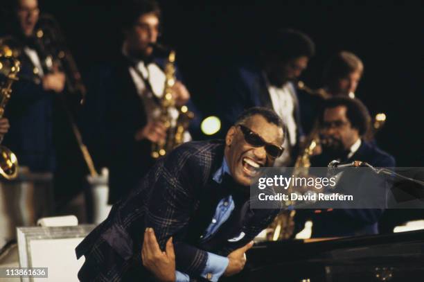 American singer, songwriter and pianist Ray Charles performs live on stage leaning forward over a piano during a concert circa 1970.