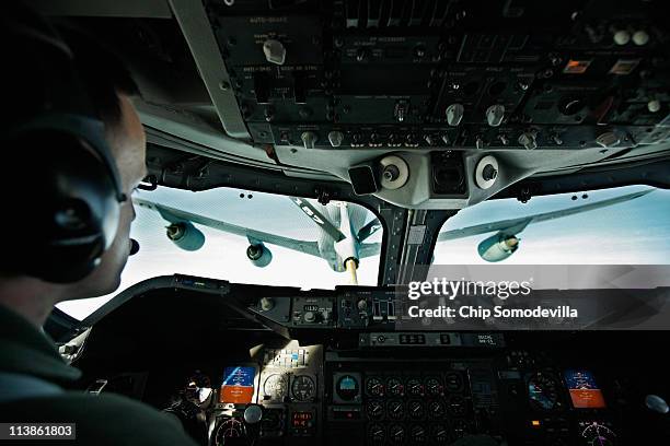 The pilot of the 747-class Boeing E-4B Advanced Airborne Command Post carefully flies the plane is it is refueled in midair by a U.S. Air Force...