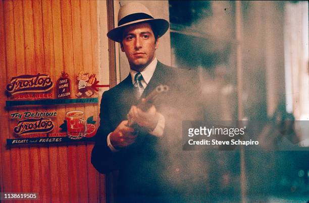 View of American actor Al Pacino fires a double-barrel shotgun in a scene from the film 'The Godfather Part II' , 1974.