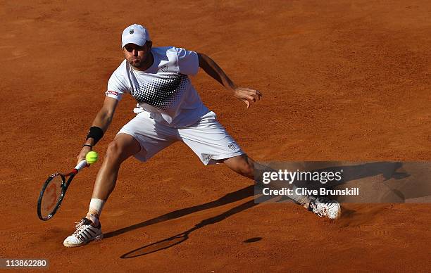 Mardy Fish of the USA stretches for a forehand during his first round match against Santiago Giraldo of Columbia during day two of the Internazoinali...