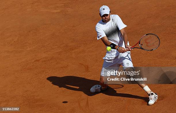 Mardy Fish of the USA plays a backhand during his first round match against Santiago Giraldo of Columbia during day two of the Internazoinali BNL...