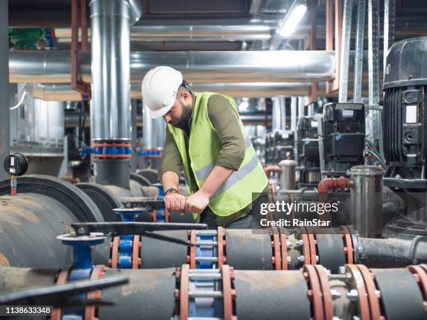 engineer working on valve in factory or utility - pump jack stock pictures, royalty-free photos & images