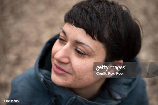 woman happy crying - emotional relief after meditating in the forest - tränen stock-fotos und bilder